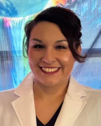 Emily Strickland, RRT, smiling in a white clinical coat